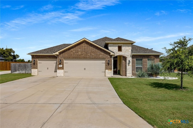 view of front of property with a front yard and a garage