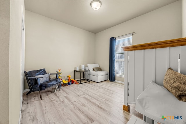 living area with light hardwood / wood-style flooring