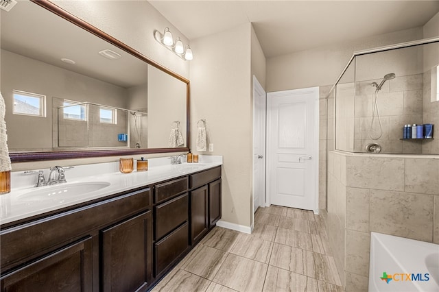 bathroom with vanity and a shower with shower door