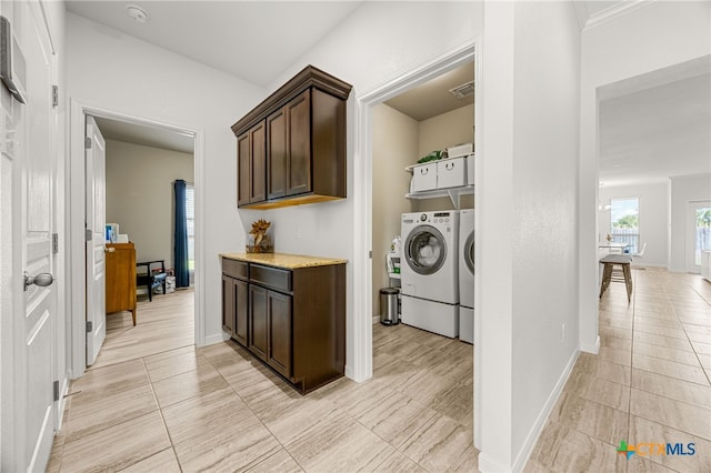 clothes washing area with separate washer and dryer and light tile patterned floors