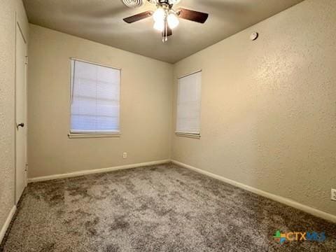 carpeted empty room featuring ceiling fan