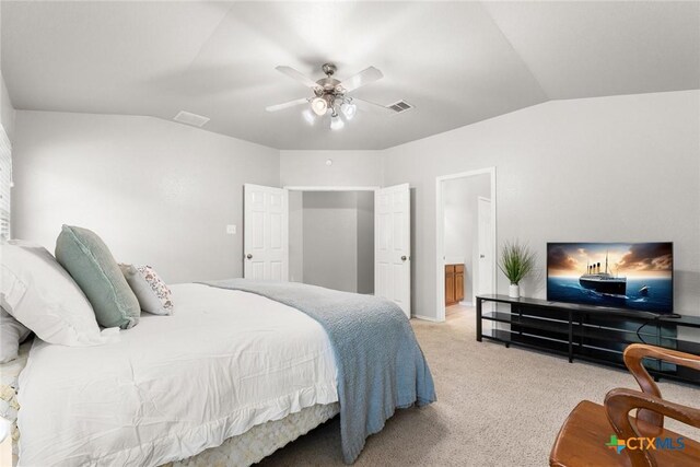 bedroom featuring visible vents, a ceiling fan, vaulted ceiling, and light colored carpet
