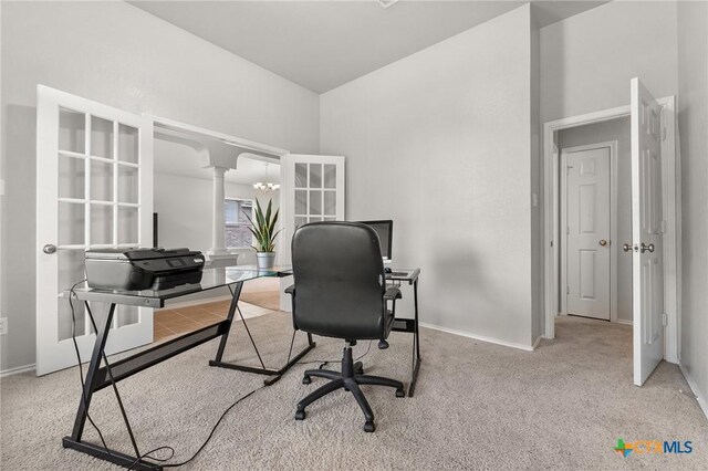 office space featuring carpet floors, ornate columns, and baseboards