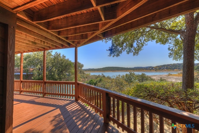 wooden deck featuring a water view