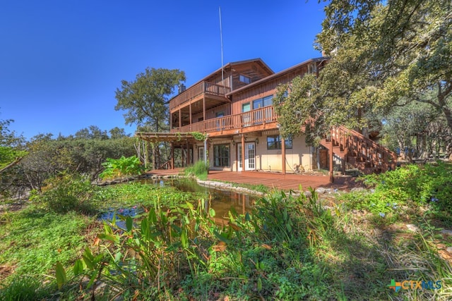 rear view of house with a balcony and a deck