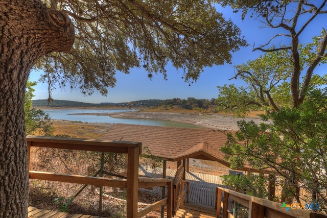 wooden terrace featuring a water view