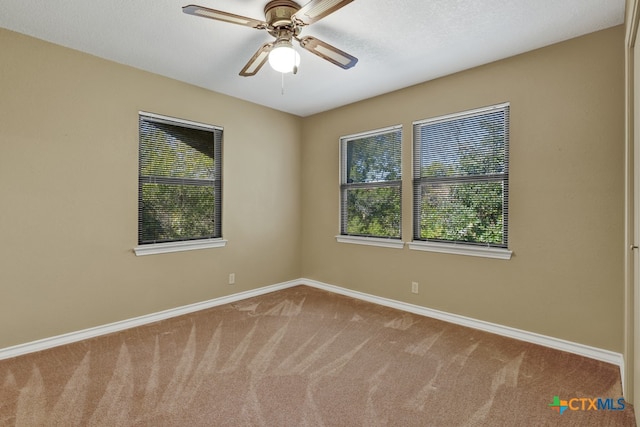 unfurnished room featuring a textured ceiling, ceiling fan, and carpet flooring