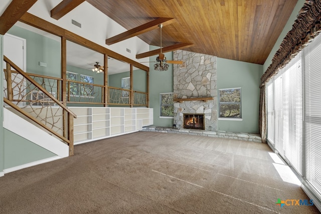 unfurnished living room with high vaulted ceiling, wooden ceiling, ceiling fan, a fireplace, and carpet