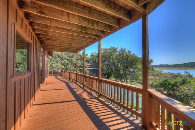 wooden terrace featuring a water view