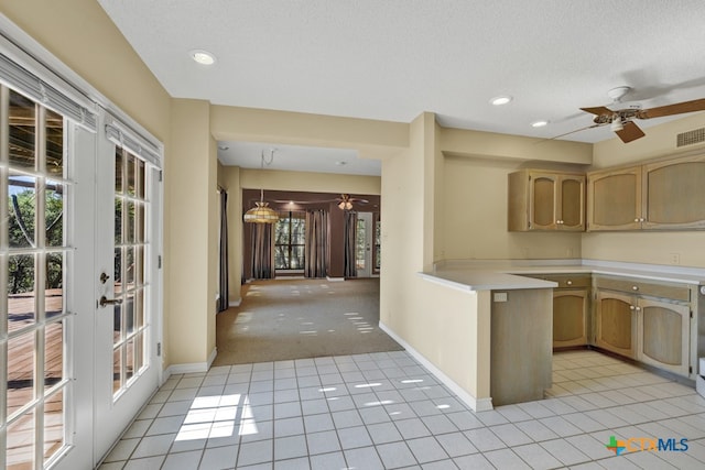 kitchen featuring a textured ceiling, light colored carpet, french doors, and ceiling fan