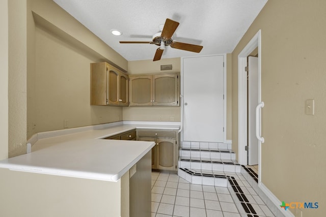 kitchen featuring light brown cabinetry, light tile patterned floors, ceiling fan, kitchen peninsula, and a textured ceiling