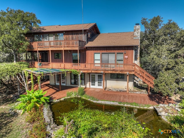 back of property with a wooden deck