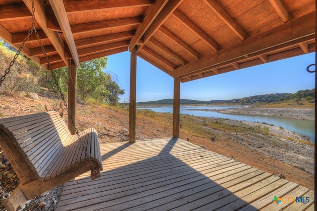 wooden terrace featuring a water view