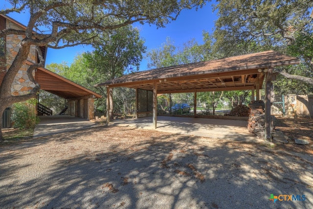 view of vehicle parking with a carport