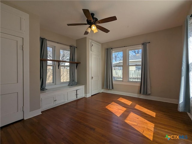207 W 5th St, Lampasas, TX 76550 - unfurnished room featuring dark wood-style flooring, plenty of natural light, and a ceiling fan