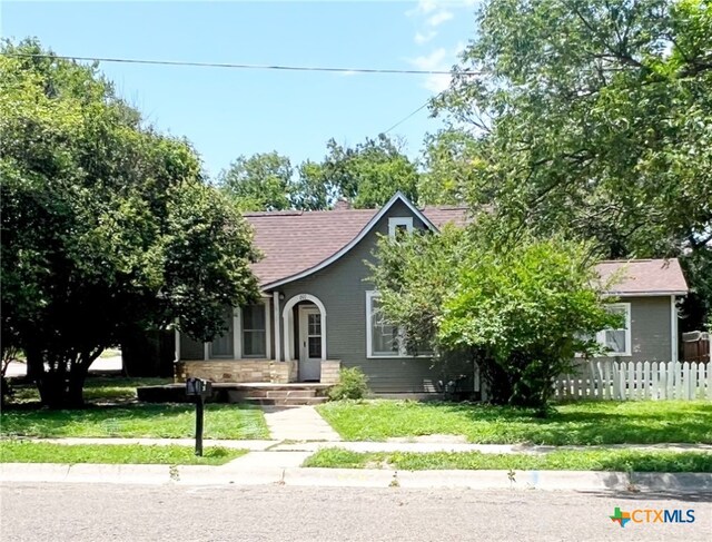 207 W 5th St, Lampasas, TX 76550 - view of property hidden behind natural elements with a shingled roof