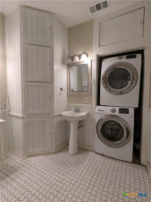 207 W 5th St, Lampasas, TX 76550 - bathroom featuring stacked washer / dryer and a sink