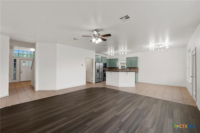 5501 Southern Belle Dr, Killeen, TX 76542 - unfurnished living room featuring light wood-style flooring, a ceiling fan, and baseboards