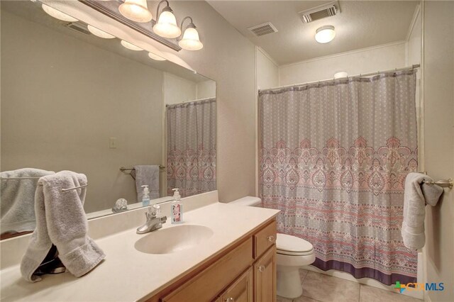 full bath with toilet, vanity, visible vents, and tile patterned floors