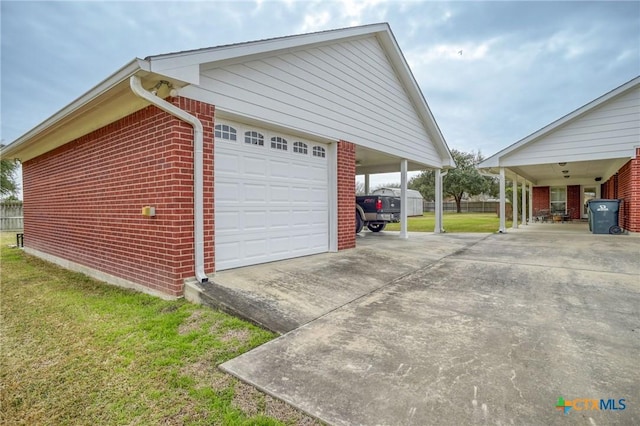 garage featuring a carport and concrete driveway