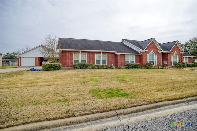 ranch-style home featuring a garage, a front yard, and brick siding