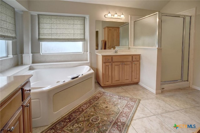 full bath with a stall shower, tile patterned flooring, a bath, and vanity