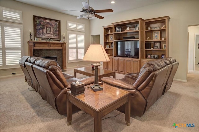 living area with baseboards, a ceiling fan, light colored carpet, a fireplace, and recessed lighting