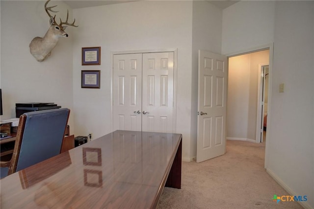 home office with light carpet and baseboards