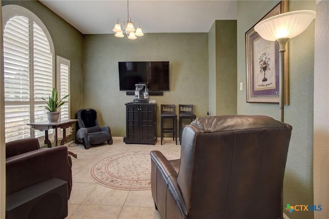 living area with an inviting chandelier and light tile patterned floors