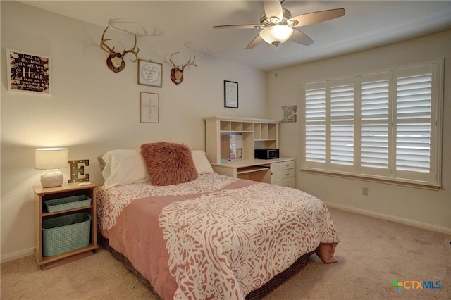 bedroom featuring light carpet, ceiling fan, and baseboards