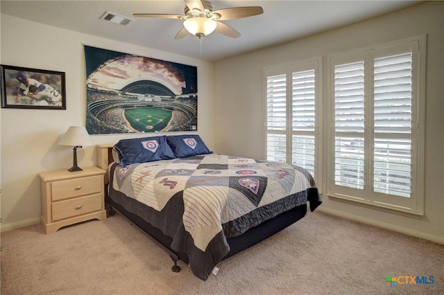 bedroom with light carpet, ceiling fan, visible vents, and baseboards