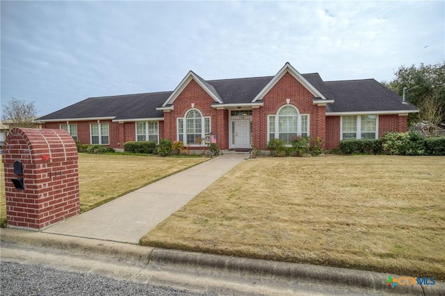 single story home with a front lawn and brick siding