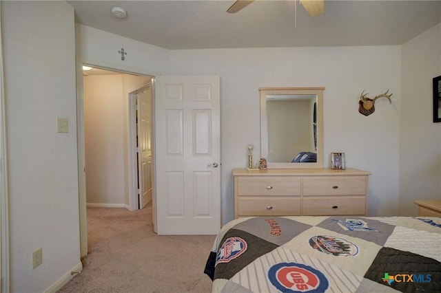 bedroom with light carpet, baseboards, and a ceiling fan