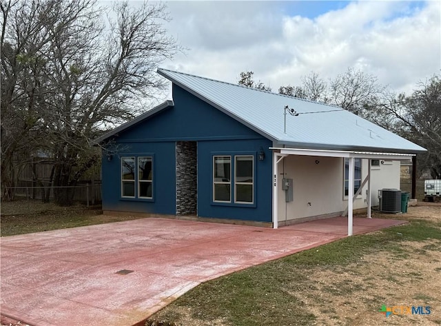 rear view of property with a yard, a patio area, and central air condition unit