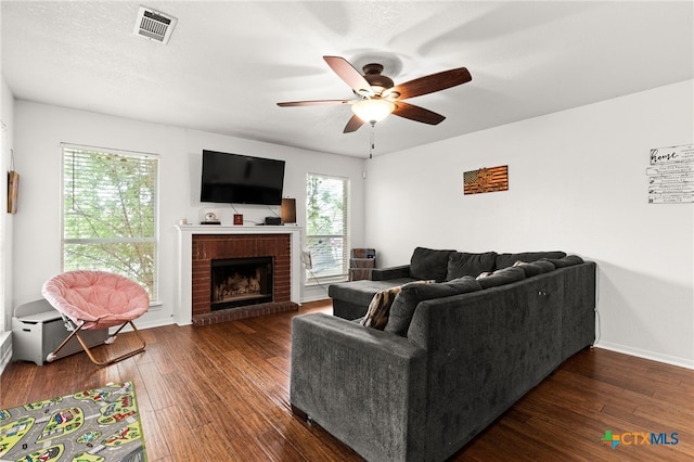 913 Risen Star Ln, Copperas Cove, TX 76522 - living area with ceiling fan, healthy amount of natural light, dark wood-style flooring, and a fireplace
