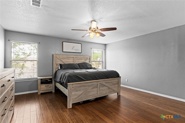 913 Risen Star Ln, Copperas Cove, TX 76522 - bedroom with baseboards, dark wood-style floors, a textured ceiling, a textured wall, and ceiling fan