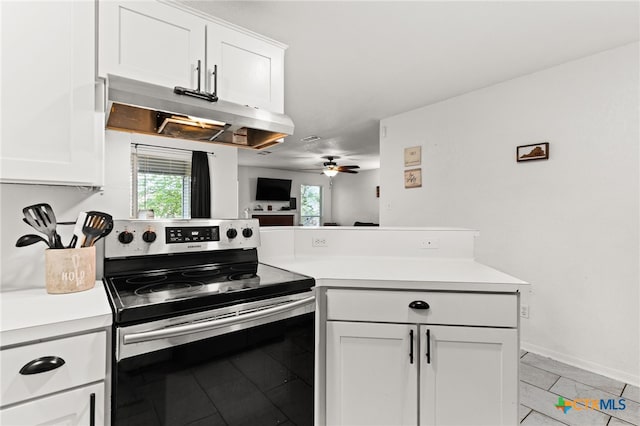 913 Risen Star Ln, Copperas Cove, TX 76522 - kitchen featuring electric stove, light countertops, under cabinet range hood, and white cabinets