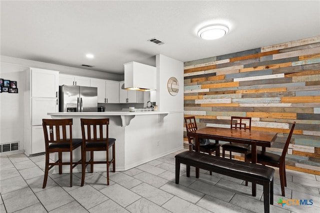 913 Risen Star Ln, Copperas Cove, TX 76522 - dining space featuring wooden walls, baseboards, and light tile patterned floors