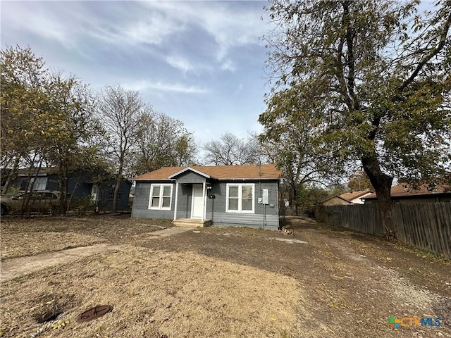 bungalow-style home featuring fence