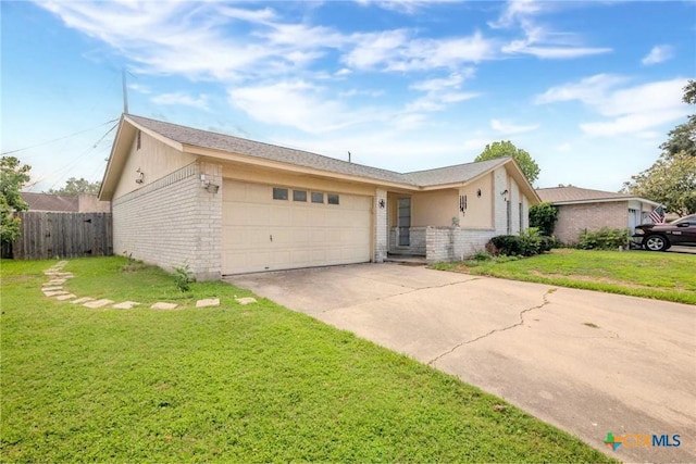 single story home with a garage and a front lawn