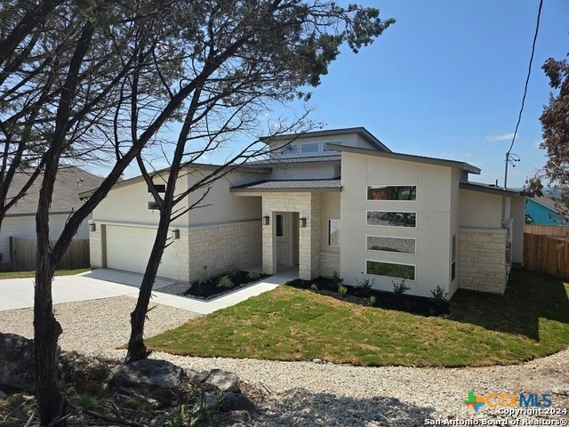 view of front facade featuring a garage and a front lawn