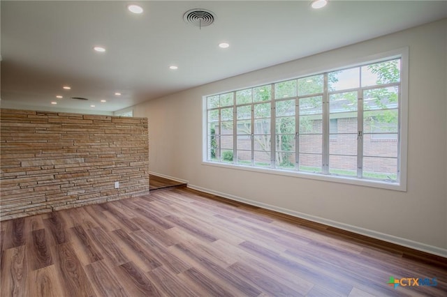 2906 Arroyo Dr, Victoria, TX 77901 - unfurnished room with wood finished floors, plenty of natural light, and recessed lighting