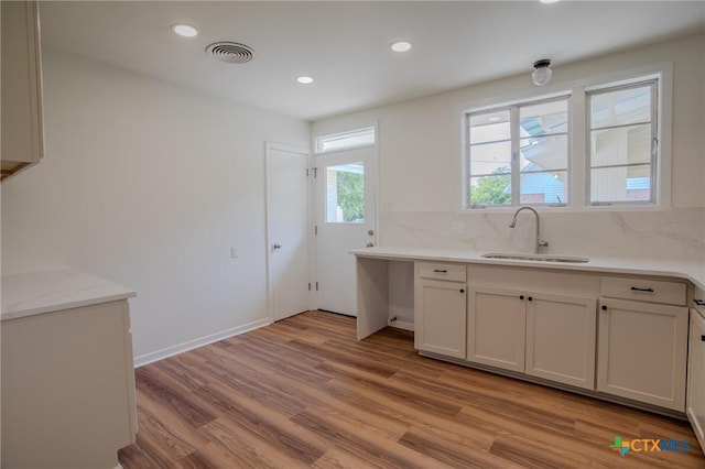 2906 Arroyo Dr, Victoria, TX 77901 - kitchen featuring light countertops, light wood-type flooring, recessed lighting, and tasteful backsplash