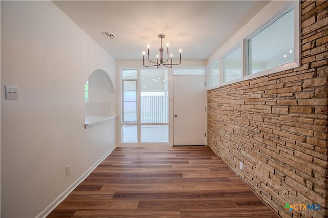 2906 Arroyo Dr, Victoria, TX 77901 - unfurnished dining area featuring a chandelier, healthy amount of natural light, and wood finished floors