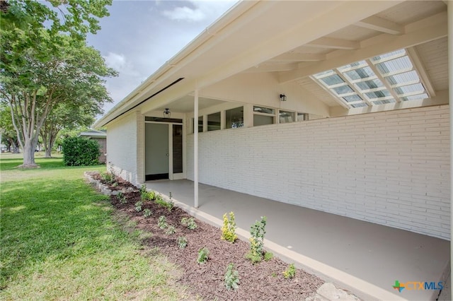 2906 Arroyo Dr, Victoria, TX 77901 - view of home's exterior with brick siding and a lawn