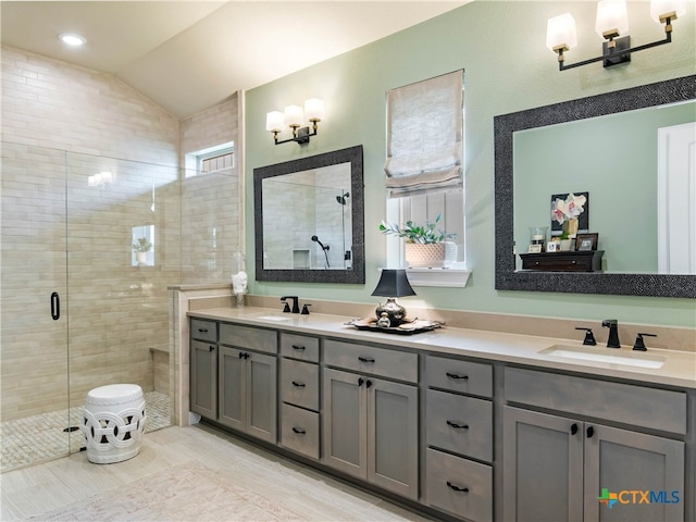 121 Wild Honeysuckle Way, San Marcos, TX 78666 - full bath featuring double vanity, a shower stall, lofted ceiling, and a chandelier