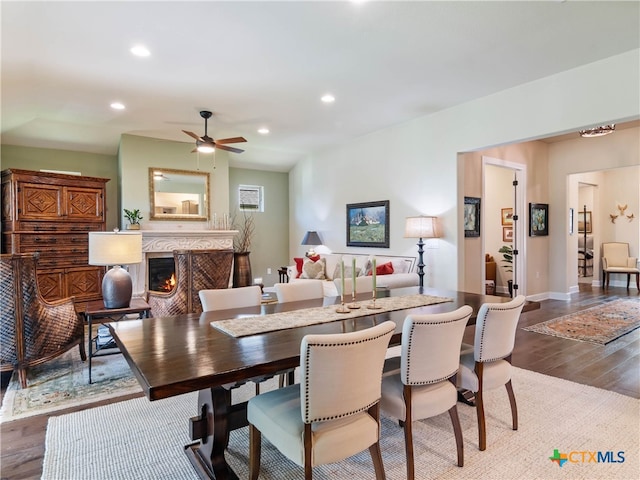 121 Wild Honeysuckle Way, San Marcos, TX 78666 - dining area with wood finished floors, a high end fireplace, ceiling fan, and recessed lighting