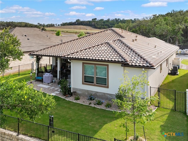 121 Wild Honeysuckle Way, San Marcos, TX 78666 - back of property with a gate, a tiled roof, central AC unit, a patio, and stucco siding