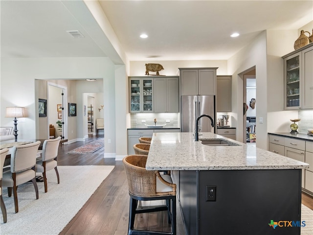 121 Wild Honeysuckle Way, San Marcos, TX 78666 - kitchen featuring a sink, freestanding refrigerator, gray cabinets, a center island with sink, and recessed lighting
