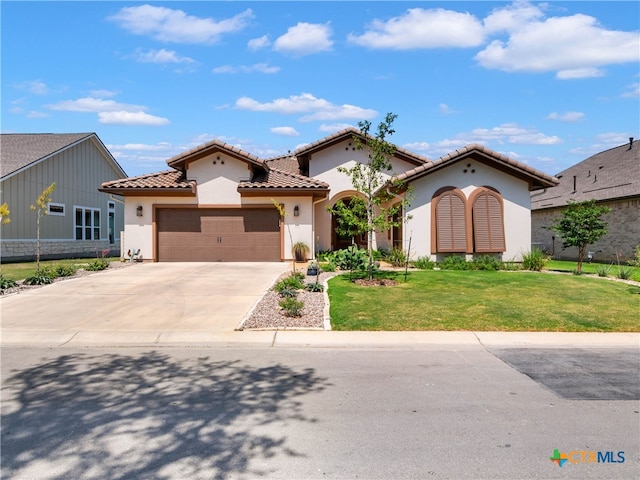 121 Wild Honeysuckle Way, San Marcos, TX 78666 - mediterranean / spanish house with stucco siding, a garage, a front lawn, driveway, and a tile roof